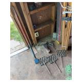 Contents of small shed includes cast-iron garden stakes, prybar, some paint supplies, lawn food