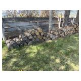 Assortment of firewood along fence