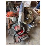 Assortment of camping items includes chairs, sleeping bags, minnow bucket, small net, frame pack, gun stocks, canteen, cook stove