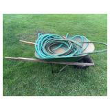 Wheel barrow and garden hoses