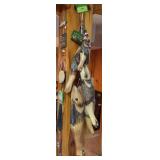 Wood log fish stringer, decor, and signs on pole and wall by storeroom