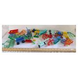 Two plastic containers of farm animals, implements, and accessories as shown