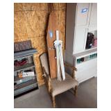 Upholstered armchair with vintage wood ironing board and vintage fold up wooden laundry dryer