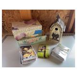 Two storage boxes, new greeting cards, and bird house