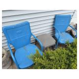 Two shell back style chairs and plastic side table
