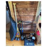 Assorted sporting goods, including a paddle, padded mat, balls and gloves, weights, helmet, etc.