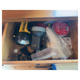 Drawers full of household maintenance type items, including batteries, flash light, light bulbs, a few miscellaneous tools