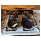 Four piece set of Calphalon cookware with three lids