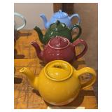 Four Lipton teapots