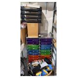 Rolling shelving unit with computer repair parts and laundry basket with camera supplies, etc