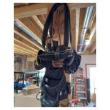 Four tools belts and a scale to weigh them with