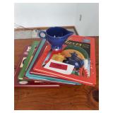 Six Fiesta reference books and creamer w chip on base