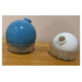 Two lightning rod balls, large blue and small white