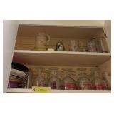 Two shelves of glassware includes many “drinking” glasses