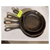 Cast iron griddle and 3 skillets