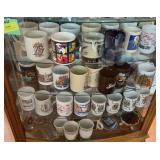 Three shelves of coffee cups and other decor
