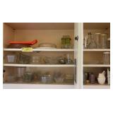 Three shelves of glassware includes corn on the cob trays, syrup dispenser, salad dressing bottles, nut chopper, etc