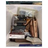 Box full of assorted pistol grips, and gun parts and pieces