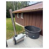 Redneck hot tub! Poly stock tank with wood burning boiler