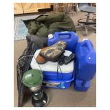 Camping items, including water jugs, sleeping bags, Coleman lantern, cooler and small pet carrier
