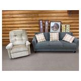 Blue/gray modern sofa with assorted floral themed artwork and La-Z-Boy recliner