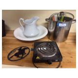 Stainless steel stock pot with assorted utensils, hot plate and ceramic pitcher and bowl set