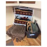 Chenille bedspread, two throw pillows, knitting needles and storage basket