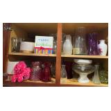 All kinds of vases in cupboard above fridge