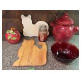 Cat cutting boards, ruby red bowl, apple dish, large urn, partially burned candle