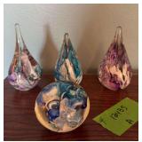 Four colorful paperweights