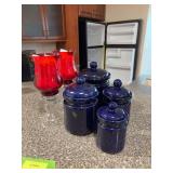 Blue canisters, red globe candle holders