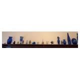 All decor on top shelf of buffet includes many blue pieces, eggs, mice, etc