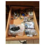 Contents of carpenter bench, kreg clamp, staples, pull saw, sanding discs, Rockler clamps