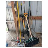 Assorted long handled yard and garden tools