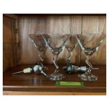 Four clear glass martini glasses and two stoppers