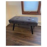 Gray Upholstered Bench features classic button tufting and sleek black angled legs-36x16x16