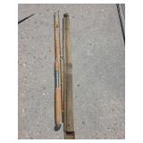 vintage multi-piece split bamboo fly fishing rod resting in a gray fabric storage sleeve.