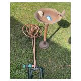 Two copper garden water spinners, and vintage cast-iron birdbath