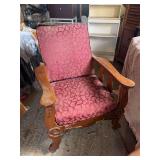 Antique early upholstered wood frame recliner on casters