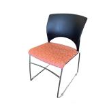 Teknion stackable side chair. Orange pattern.