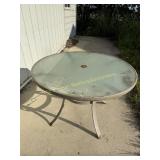 Round patio table with glass top 29' tall 42' wide