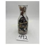 Glass Wine Carafe full of vintage jewelry