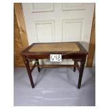 Antique bench with cane seat