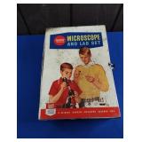 GILBERT MICROSCOPE AND LAB SET TIN W/TOY ANIMALS,