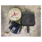Binoculars, clock and square cast iron skillet