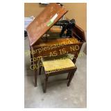 Singer sewing machine in table with bench