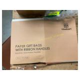 Colored gift bags with ribbon handles.