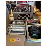 Box of 24 dvds, box of 45 rpm records, & milk crat