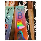 Two skeleton signs and a hey boo sign