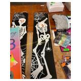A skeleton sign and a welcome Halloween sign
